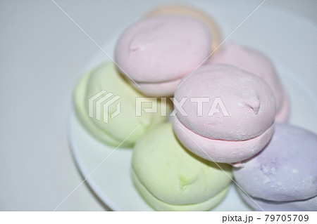 Colorful delicious marshmallows on a white plate Colorful delicious marshmallows on a white plate 79705709