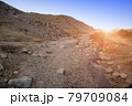 rocky road in the foothills at sunset. Uzbekistan 79709084