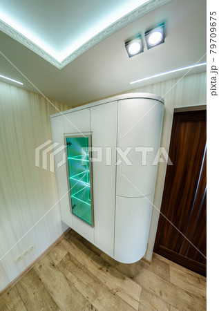 Modern furniture in a minimalist design executed in white color in a home interior. Modern furniture in a minimalist design executed in white color in a home interior. 79709675