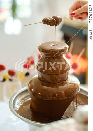 Fondue with a chocolate fountain and sweets for it.Sweet theme Fondue with a chocolate fountain and sweets for it.Sweet theme 79709822