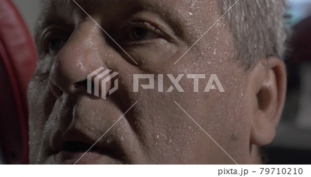 Man wiping sweaty face with towel Man wiping sweaty face with towel 79710210