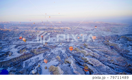 Colorful balloons over volcanic rocks in Cappadocia. Turkey. 79711489