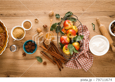 Ingredients for cooking Thanksgiving autumn apple pie with fresh fruits, cinnamon and walnuts on wooden table, top view 79711674