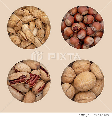 Four types of unpeeled nuts in holes on an eco background. 79712489
