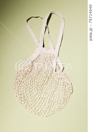 Reusable cotton shopping string bag on green background. Zero waste concept. No plastic 79714040