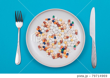 Pharmaceutical Industry and Medicinal Products - Colored Pills on Plate 79714969