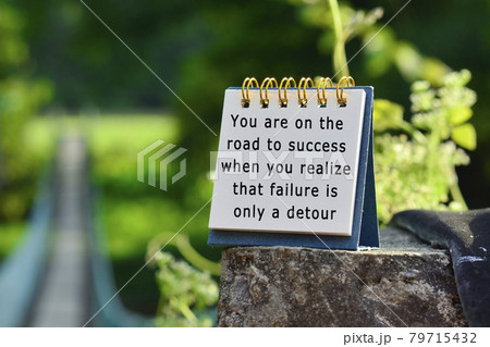 Motivational quote on white note with blurred background of hanging bridge 79715432