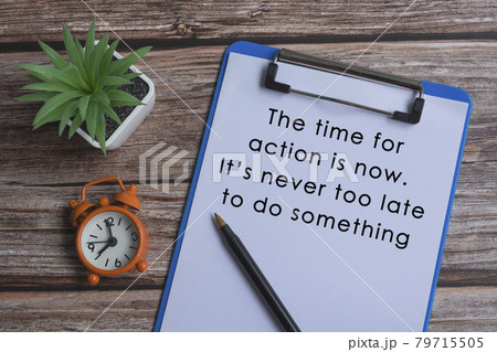 Text on blue clipboard with pen, alarm clock and potted plant on wooden desk Text on blue clipboard with pen, alarm clock and potted plant on wooden desk 79715505