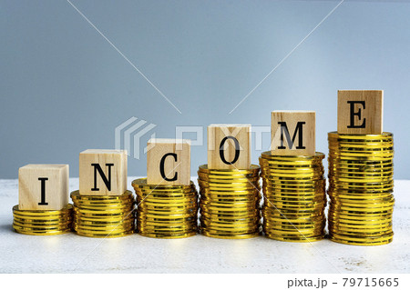 Income text on wood block with a pile of coins Income text on wood block with a pile of coins 79715665