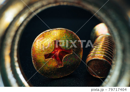 Metal screws and nuts on black background Metal screws and nuts on black background 79717404