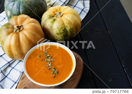 Homemade pumpkin soup on a black table Homemade pumpkin soup on a black table 79717766