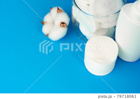 Stack of cotton discs and skicare cosmetic bottle Stack of cotton discs and skicare cosmetic bottle 79718061
