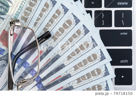 US banknotes on keyboard computer 79718150