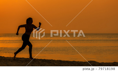 Silhouette athletic woman jogging exercise and relax and freedom on sand beach. Silhouette athletic woman jogging exercise and relax and freedom on sand beach. 79718198