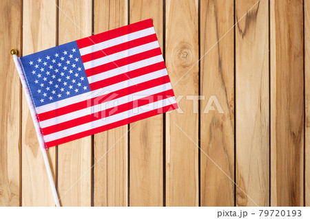 United States of America flag on wooden table background. USA holiday of Veterans, Memorial, Independence ( Fourth of July) and Labor Day concept United States of America flag on wooden table background. USA holiday of Veterans, Memorial, Independence ( Fourth of July) and Labor Day concept 79720193
