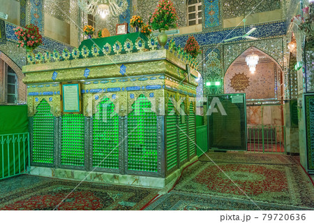 The tomb, holy shrine in the middle of the Shia mosque in Yazd, Iran. Small pieces of mirrors, glued on the walls of mosque, reflect the light beams and create beautiful colourful effects. 79720636