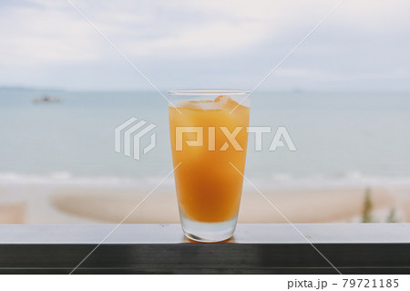Juice in a glass with sea view background in concept of summer. 79721185
