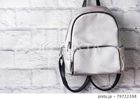 Shiny silver backpack on the background of a brick wall. Copy space Shiny silver backpack on the background of a brick wall. Copy space 79722398