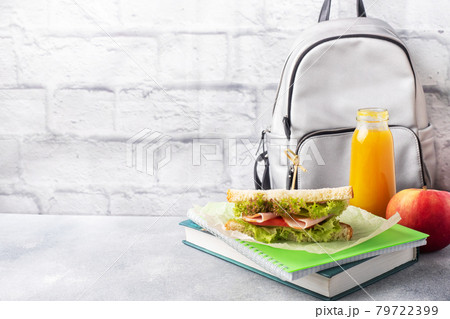 Snack for school with sandwich, fresh Apple and orange juice. Colorful school supplies, Copy space, Snack for school with sandwich, fresh Apple and orange juice. Colorful school supplies, Copy space, 79722399