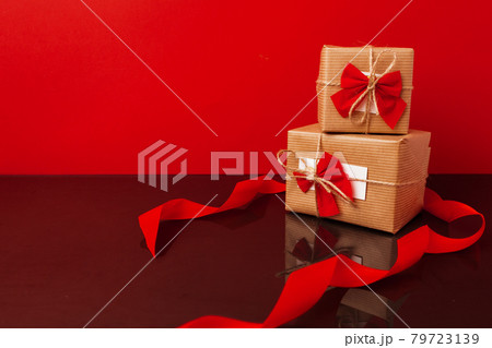 Two wrapped gift boxes for Christmas on red Two wrapped gift boxes for Christmas on red 79723139