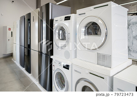 Row of new washing machines in a hypermarket Row of new washing machines in a hypermarket 79723473