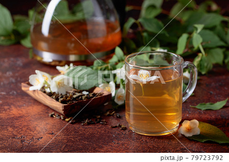 Green tea with jasmine in cup and teapot . Green tea with jasmine in cup and teapot . 79723792