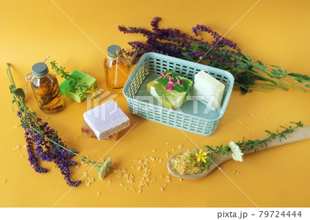 Aromatic oil, medicinal herbs, natural soap and salt on a bright background, concept of spa, body care, alternative medicine, home cosmetics preparation 79724444