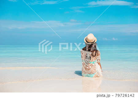 Woman laying on the beach enjoying summer holidays looking at the sea Woman laying on the beach enjoying summer holidays looking at the sea 79726142