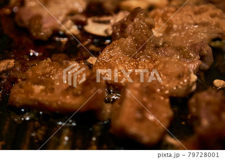 Korean-style meat pieces on the table grill, narrow depth of field 79728001