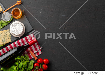 Composition with wine bottle and cheese assortment on grey background Composition with wine bottle and cheese assortment on grey background 79728530