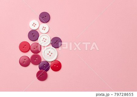 Plastic buttons on pink pastel background top view 79728655