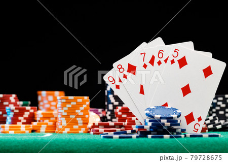 Poker chips and playing cards on black background 79728675