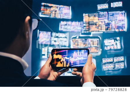 Business man using mobile phone app analytics for financial stock market graph trading. Business man using mobile phone app analytics for financial stock market graph trading. 79728828