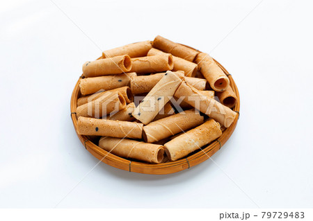 Thai crispy coconut rolls with sesame in bamboo basket on white 79729483