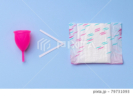 Menstrual cup and hygienic pad on paper background Menstrual cup and hygienic pad on paper background 79731093
