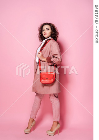 Young elegant woman in trendy pink coat. isolated studio shot 79731990