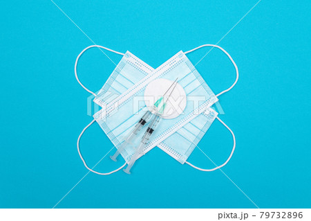 Vaccination or Revaccination Concept - Two Medical Syringe on Blue Table Vaccination or Revaccination Concept - Two Medical Syringe on Blue Table 79732896
