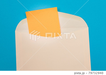 Beige Envelope with Blank Orange Sheet of Paper Inside Beige Envelope with Blank Orange Sheet of Paper Inside 79732940