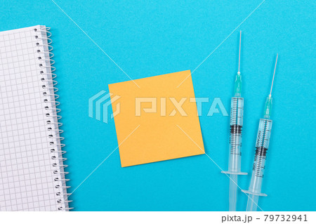 Vaccination or Revaccination Concept - Two Medical Syringe on Blue Table 79732941
