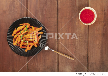 Roasted sweet potato fries with rosemary and ketchup, shot from the top 79733670