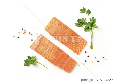 Slices of salmon with parsley and pepper, on a white background with copy space, overhead photo 79733727