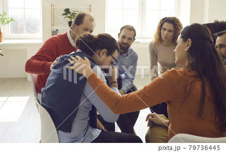Participant giving support during therapy group meeting or training session 79736445