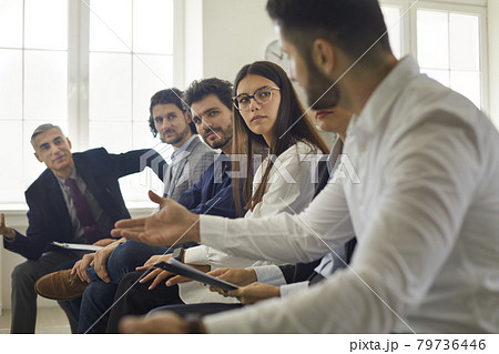 Group of people sitting in row, communicating and listening to each other's opinions 79736446