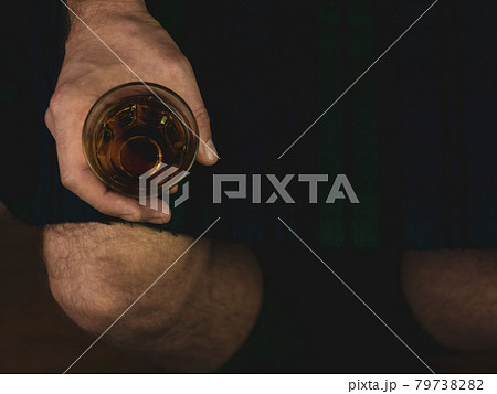 Irish man in green kilt celebrating St. Patrick's Day with scotch drink glass in hand Scottish guy drinks whiskey in pub Irish man in green kilt celebrating St. Patrick's Day with scotch drink glass in hand Scottish guy drinks whiskey in pub 79738282