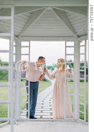 Happy pleasant mature couple in love, standing together outdoors and enjoying the scent of lavender Happy pleasant mature couple in love, standing together outdoors and enjoying the scent of lavender 79738367