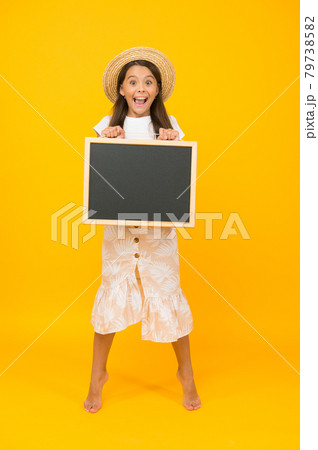 summer holiday is here. cheerful little girl with blackboard 79738582
