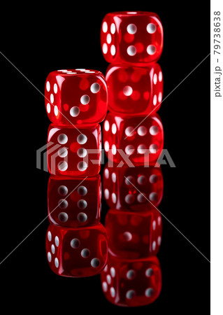 Red casino dice isolated over black reflective background 79738638