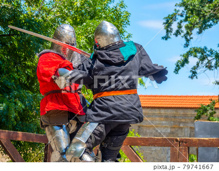Two Medieval Warriors Fighting on Swords 79741667
