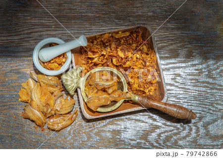 Dried chilli paste with crispy fish thai style or Crispy fish chilli paste on wooden bowl. Dried chilli paste with crispy fish thai style or Crispy fish chilli paste on wooden bowl. 79742866
