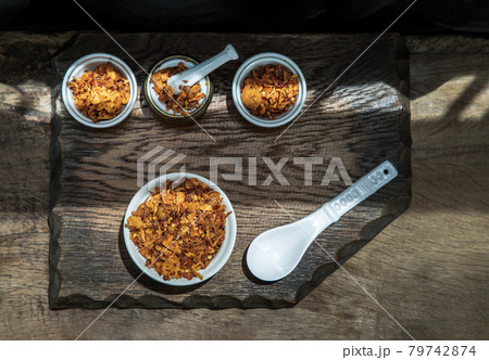 Dried chilli paste with crispy shrimp thai style or Crispy shrimp chilli paste in ceramic white cup on old wooden table. 79742874